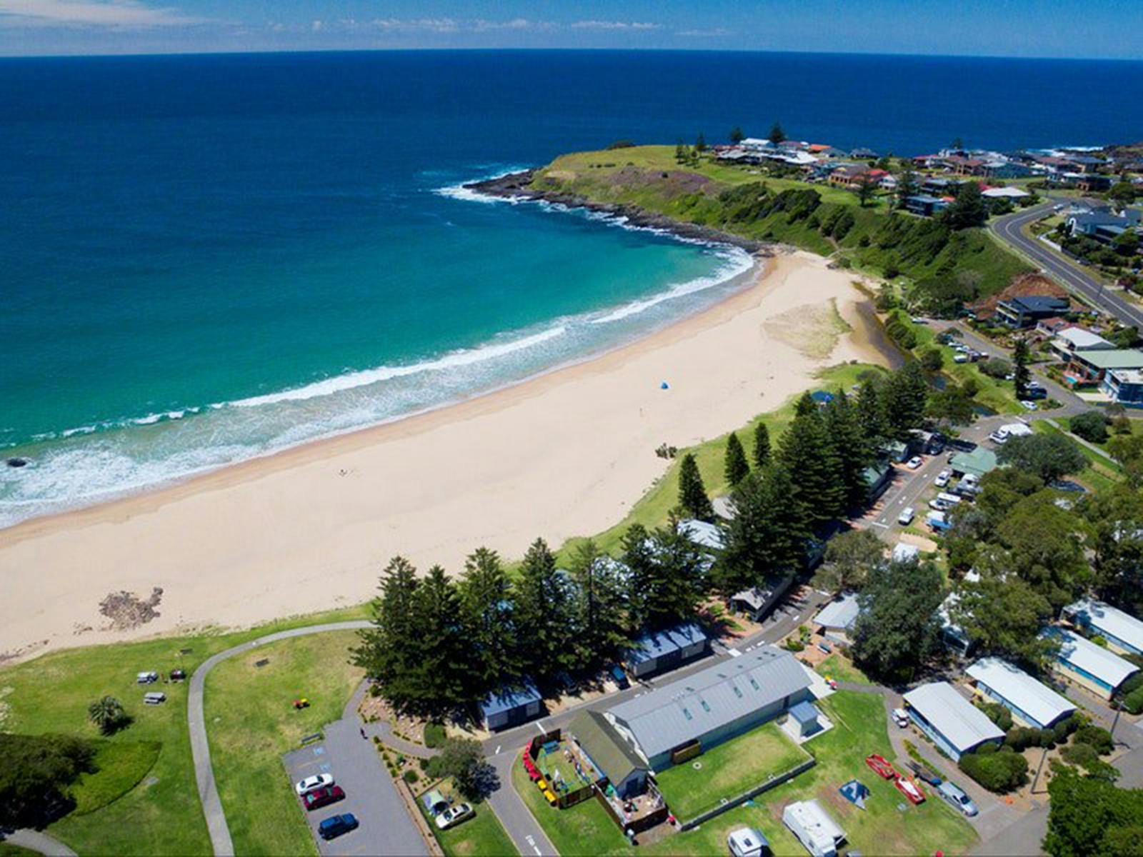 Kendalls Beach curving around a turquoise bay in Kiama